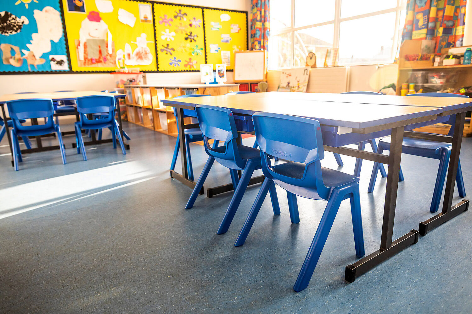 Photo of a classroom at Victoria Primary School with plastic school chairs and tables