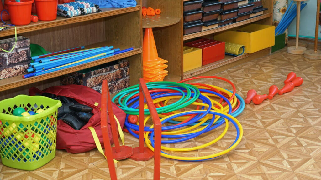 Plastic and wooden sport and therapeutic equipment on floor of gym